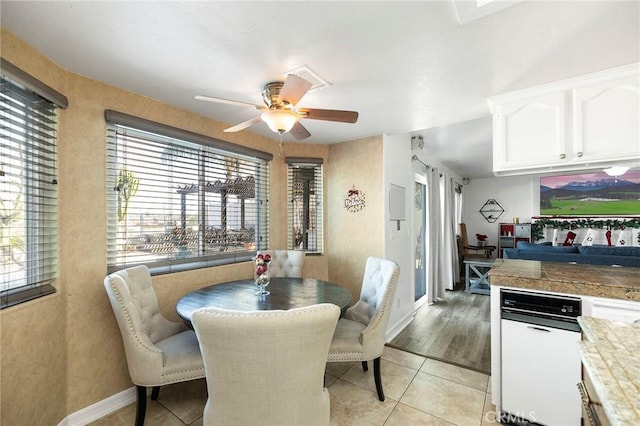 dining area with ceiling fan and light hardwood / wood-style flooring