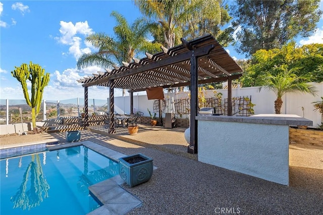 view of pool featuring a pergola, a patio area, a mountain view, and a bar