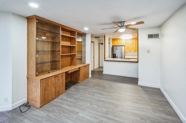 unfurnished living room featuring hardwood / wood-style floors and ceiling fan