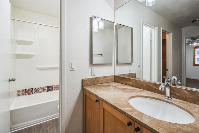 bathroom featuring hardwood / wood-style floors, vanity, and a tub to relax in