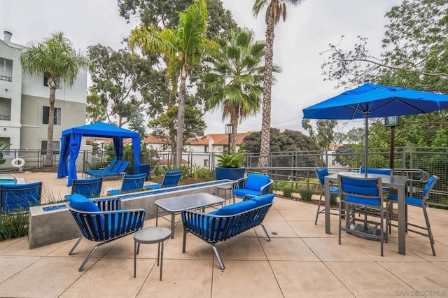 view of patio / terrace featuring a gazebo and a fire pit