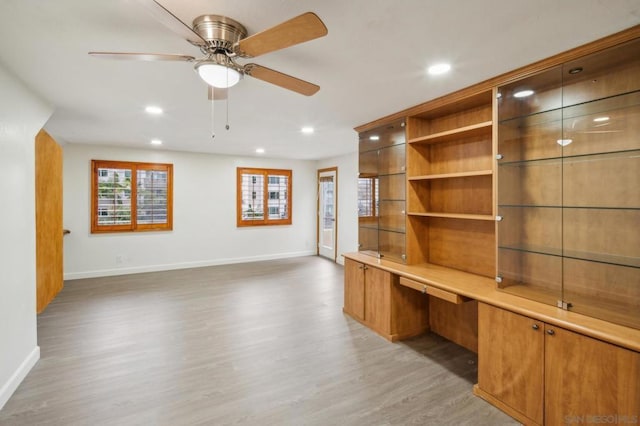 unfurnished office featuring ceiling fan and dark wood-type flooring