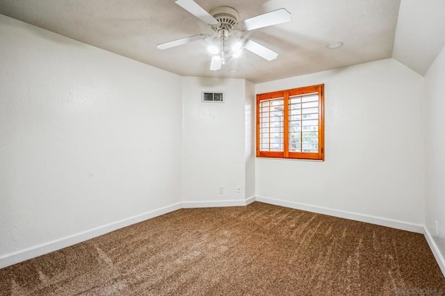 carpeted empty room featuring ceiling fan and lofted ceiling