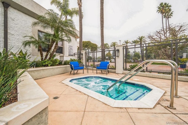 view of pool with a hot tub