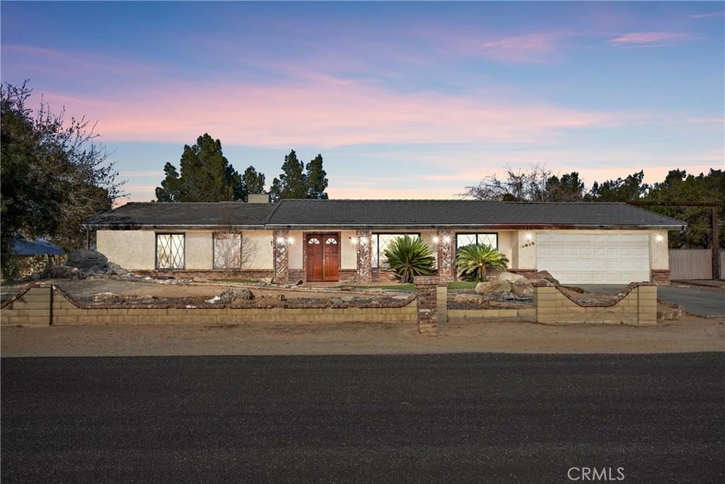 single story home featuring a garage