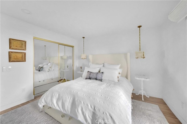 bedroom with a closet and hardwood / wood-style flooring