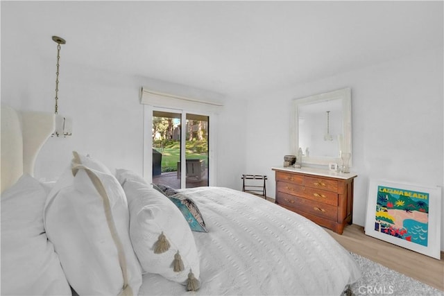 bedroom featuring light hardwood / wood-style floors and access to outside