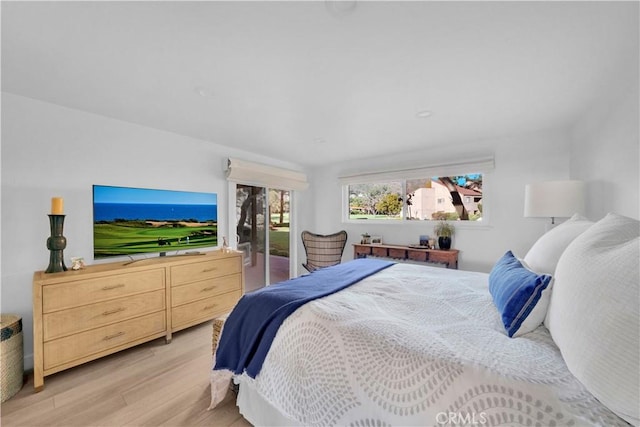 bedroom featuring access to exterior and light wood-type flooring