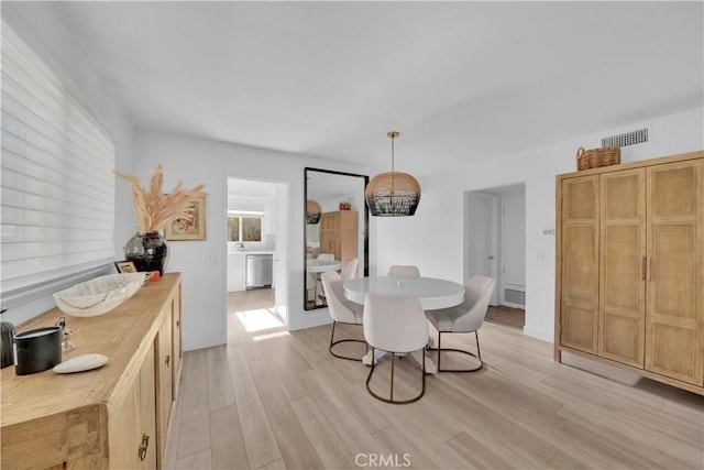 dining space featuring light wood-type flooring