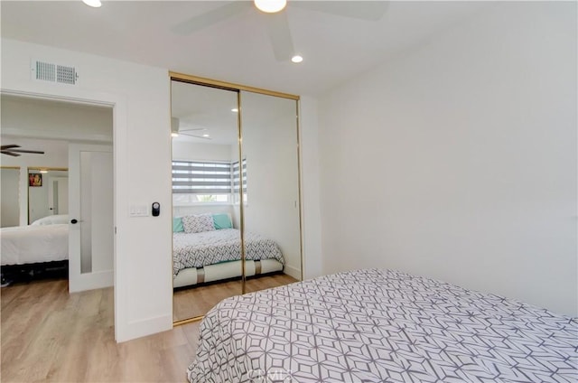 bedroom with light wood-type flooring, a closet, and ceiling fan