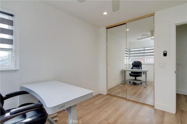 home office featuring ceiling fan and light hardwood / wood-style floors