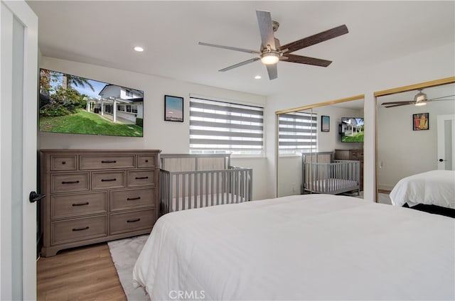 bedroom with ceiling fan and light wood-type flooring