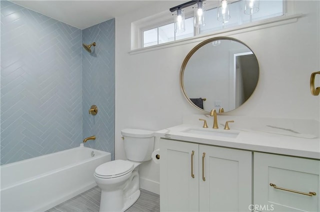 full bathroom with vanity, toilet, and tiled shower / bath