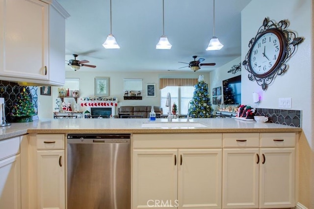 kitchen with dishwasher, sink, tasteful backsplash, kitchen peninsula, and decorative light fixtures