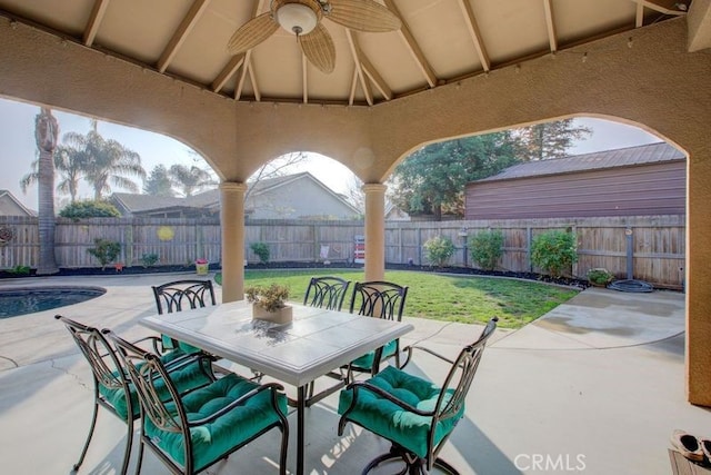 view of patio featuring ceiling fan and a fenced in pool