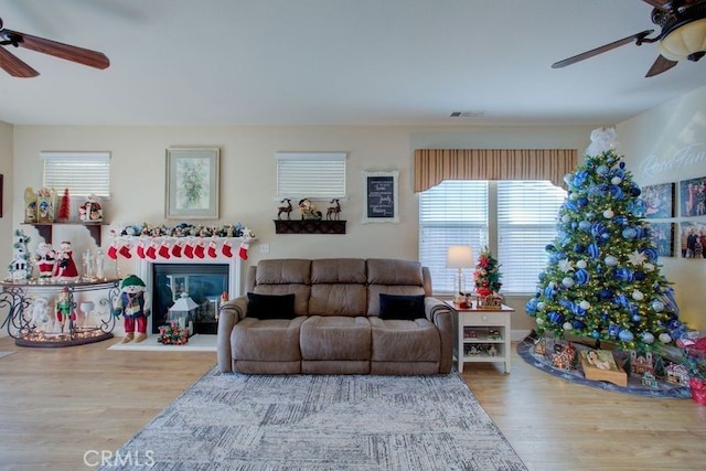 living room featuring hardwood / wood-style flooring and ceiling fan