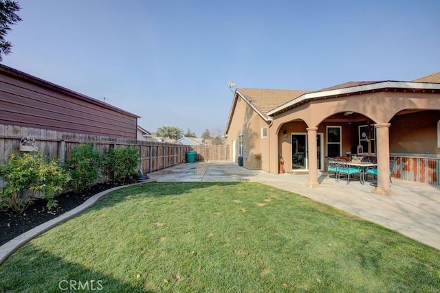 back of house featuring a yard and a patio