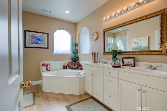 bathroom featuring separate shower and tub, hardwood / wood-style floors, and vanity