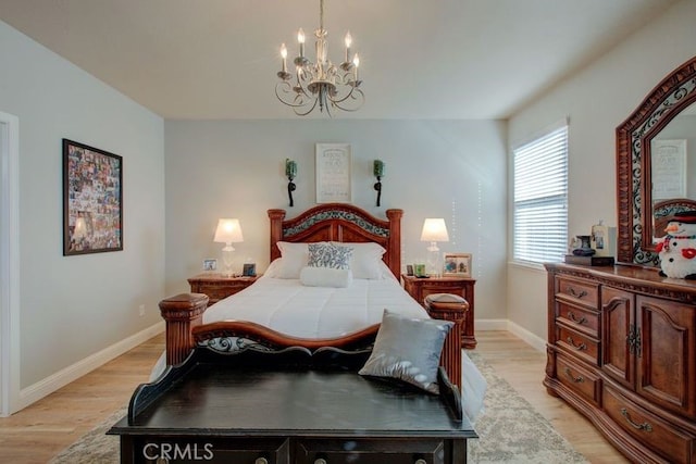 bedroom with a chandelier and light hardwood / wood-style flooring