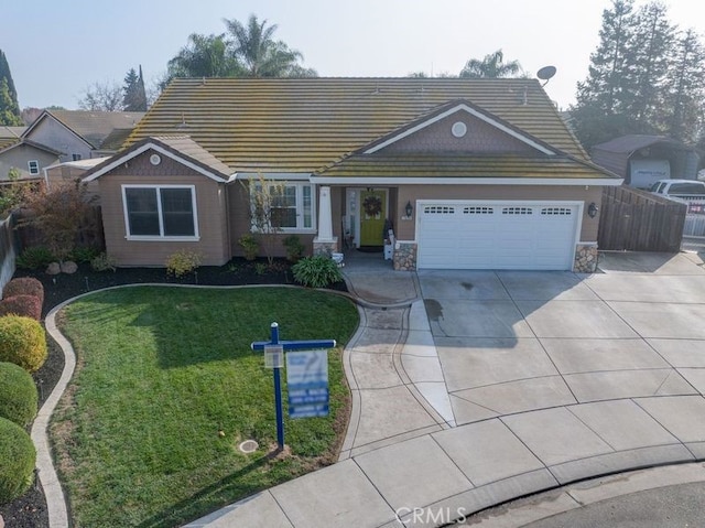 single story home featuring a garage and a front lawn