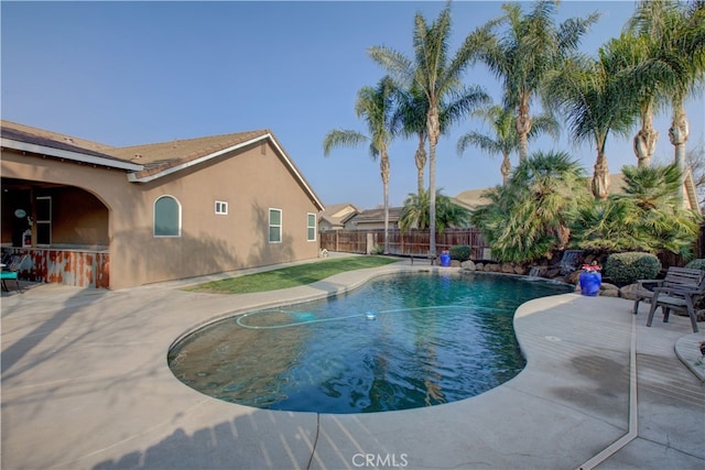 view of swimming pool with a patio and exterior bar