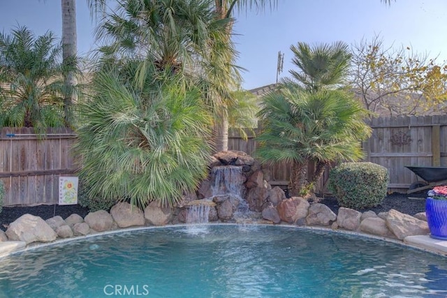 view of swimming pool featuring pool water feature