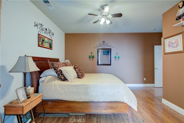 bedroom with ceiling fan and light hardwood / wood-style floors