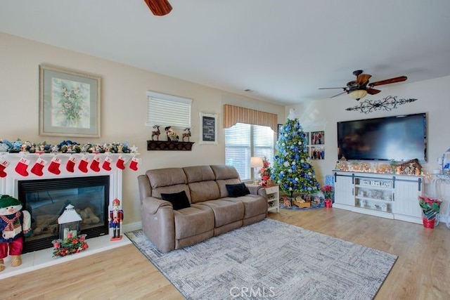 living room featuring hardwood / wood-style floors and ceiling fan