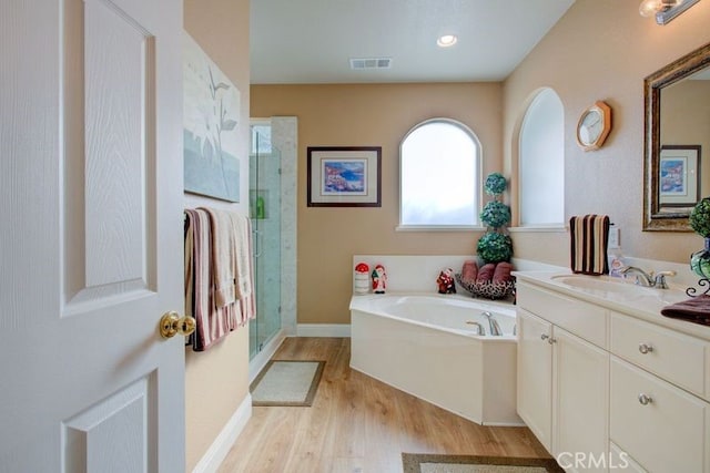 bathroom with vanity, separate shower and tub, and wood-type flooring