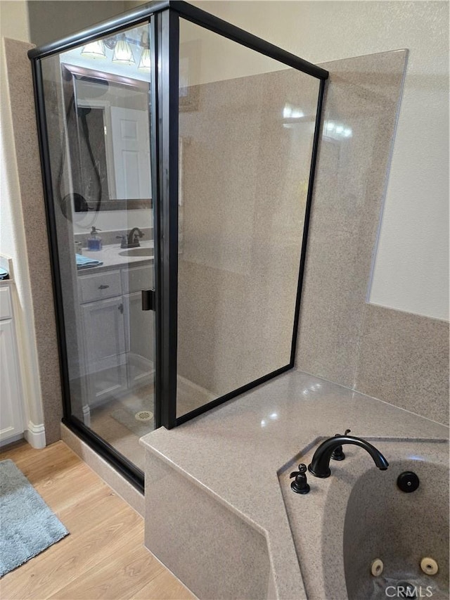 bathroom with vanity, wood-type flooring, and independent shower and bath