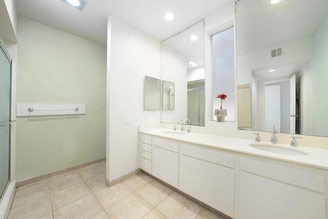 bathroom featuring vanity, tile patterned floors, and a shower with shower door