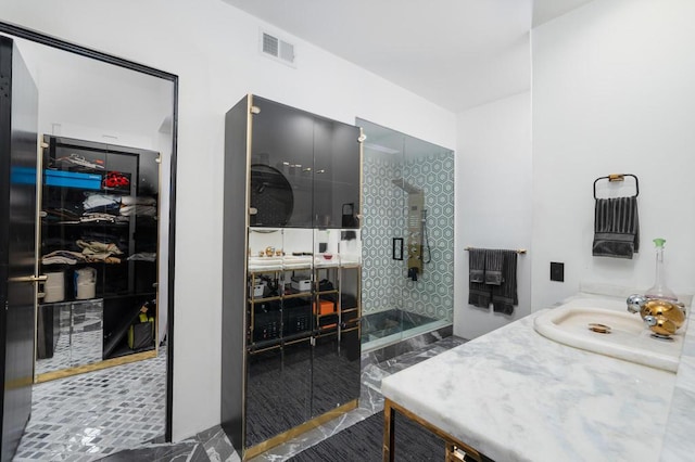 bathroom featuring vanity and a shower with shower door