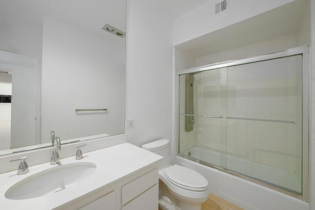 full bathroom with toilet, combined bath / shower with glass door, and vanity