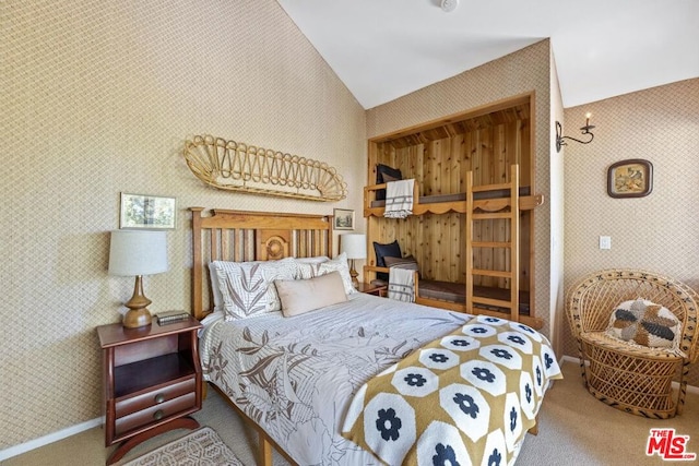 carpeted bedroom with vaulted ceiling