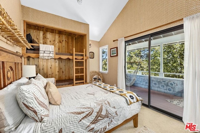 carpeted bedroom featuring access to exterior and lofted ceiling