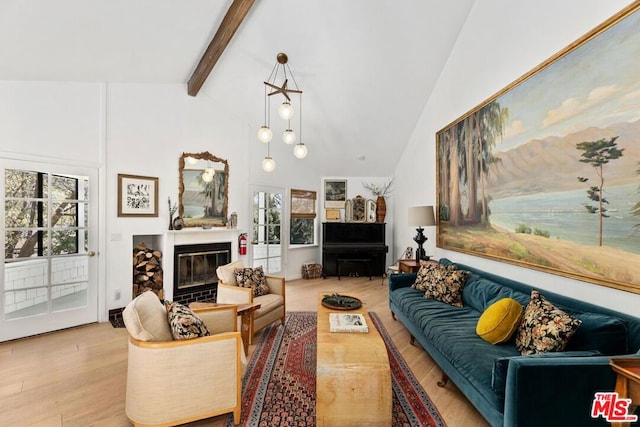 living room with beamed ceiling, light hardwood / wood-style floors, and high vaulted ceiling