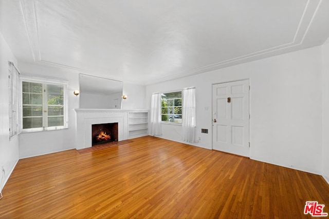 unfurnished living room featuring hardwood / wood-style floors and a fireplace