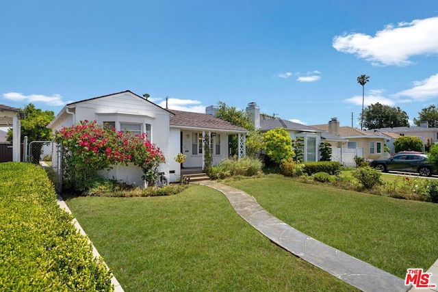 ranch-style home featuring a front yard