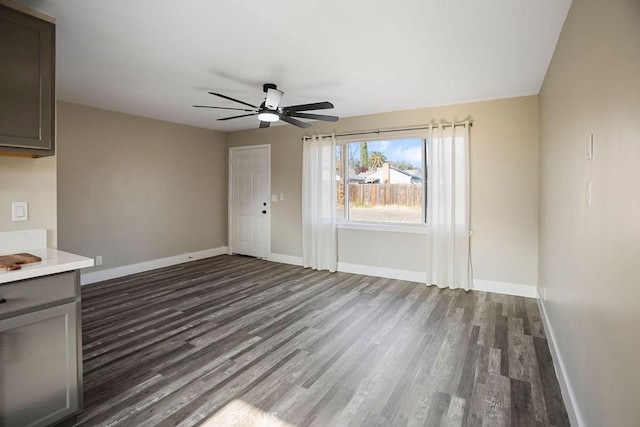 unfurnished living room with ceiling fan and dark hardwood / wood-style flooring