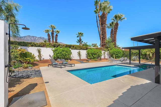 view of pool featuring a mountain view and a patio area