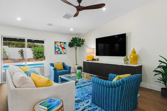 living room featuring hardwood / wood-style flooring, ceiling fan, and vaulted ceiling