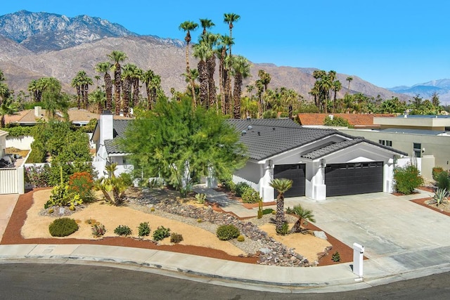 view of front of home with a mountain view and a garage