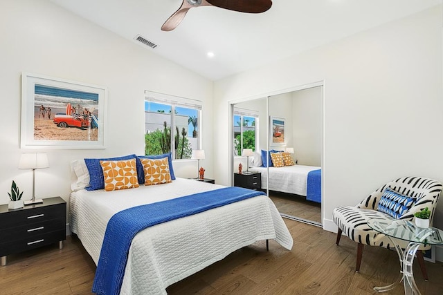 bedroom featuring ceiling fan, vaulted ceiling, dark hardwood / wood-style flooring, and a closet