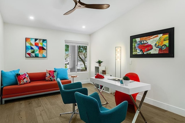 home office featuring hardwood / wood-style flooring, vaulted ceiling, and ceiling fan