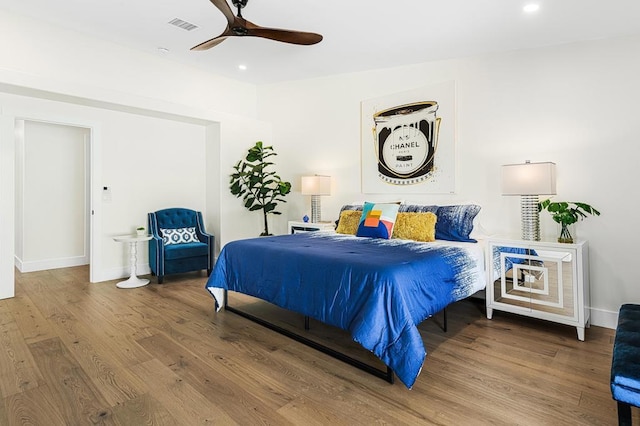 bedroom with hardwood / wood-style floors and ceiling fan