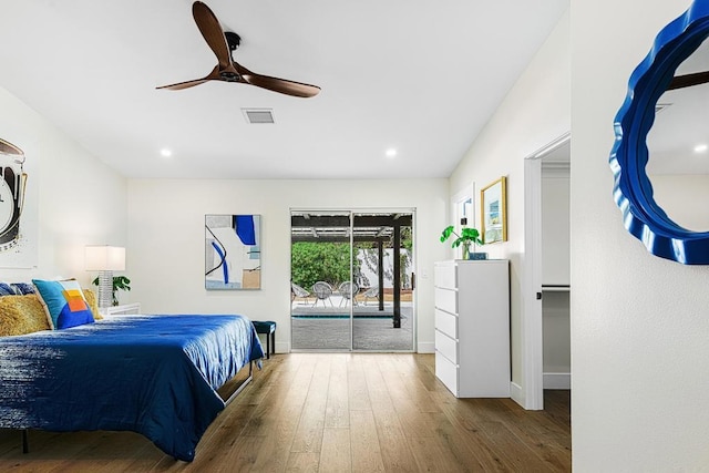 bedroom with access to exterior, hardwood / wood-style floors, and ceiling fan