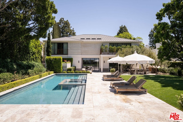 rear view of house with a yard and a patio