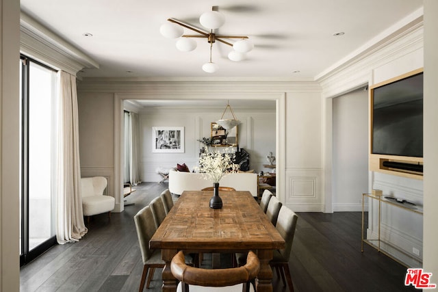 dining space with crown molding, dark wood-type flooring, and an inviting chandelier