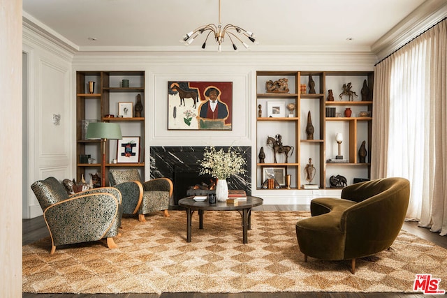 sitting room featuring crown molding, a healthy amount of sunlight, and an inviting chandelier