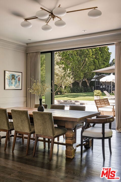 dining area with crown molding, plenty of natural light, and dark hardwood / wood-style flooring